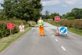 Worker in front of road closed signs on a UK road