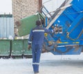 Worker at garbage collection, loading barrels in a garbage can Royalty Free Stock Photo