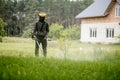 Worker with a gas mower in his hands, mowing grass in front of the house. Trimmer in the hands of a man. Gardener cutting the Royalty Free Stock Photo