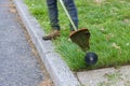 Worker in gasoline mower in hand man mows the grass with string trimmer Royalty Free Stock Photo