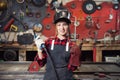 Worker girl welder on steel structure in factory, light spark