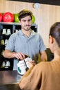 Worker giving shoes to customer for bowling Royalty Free Stock Photo