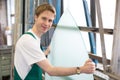 Worker in glazier's workshop handling glass Royalty Free Stock Photo