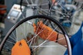 Worker in gloves installs bicycle spokes, factory Royalty Free Stock Photo