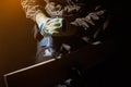 Worker in gloves working with electrical jigsaw