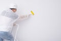 the worker glues the wallpaper with a roller expelling air and glue