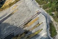 A worker going upstair by temporary stairway on very high slope