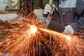 Worker with a grinder cuts a metal pipe Royalty Free Stock Photo