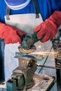 Worker grinding metal with a grinder and cleaning steel seam. Working in a metal Royalty Free Stock Photo