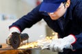Worker grinding a metal plate Royalty Free Stock Photo