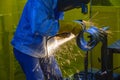 The worker grinding the steel pipe after welding Royalty Free Stock Photo