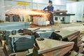 Worker grinding weld seam with grinder machine and sparks Royalty Free Stock Photo