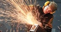 Worker grinding weld seam with grinder machine and sparks Royalty Free Stock Photo