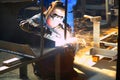 Worker grinding/welding metal