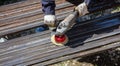 A worker grinds a rusty metal pipe Royalty Free Stock Photo