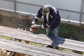 A worker grinds a rusty metal pipe Royalty Free Stock Photo