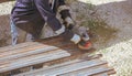 A worker grinds a rusty metal pipe Royalty Free Stock Photo