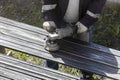A worker grinds a rusty metal pipe Royalty Free Stock Photo