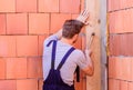 Worker with hammer brick wall background. Building and construction. Engineer with hammer tool. General maintenance and