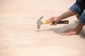 Worker hammering wooden wall Royalty Free Stock Photo