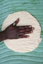 Worker hand on an african pancake