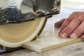 Worker hand cutting ceramic tile with water cutting machine close-up. Royalty Free Stock Photo