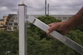 Worker hand holding inspecting industry Aluminium safety ladder gate rooftop high rise building