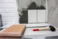 The worker hand is putting tiles adhesive to the wall with the notched trowel Royalty Free Stock Photo