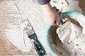 Worker hand with spatula and plaster, build work Royalty Free Stock Photo