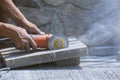 Worker hand using grinder cutting stone tile floor for paving pavement Royalty Free Stock Photo