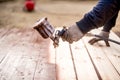 Worker hand using spray gun and painting wood Royalty Free Stock Photo