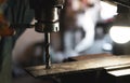 Worker hand working on milling machine to change metal drill bit. Tool for drilling metal workpiece. Milling machine. Steel Royalty Free Stock Photo