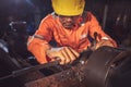 Worker handles metal at lathe Turner measures the dimensions of the metal workpiece with a caliper in uniform with safety. Work on Royalty Free Stock Photo