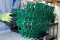 Worker handling green printed circuit board panels at electronics factory Royalty Free Stock Photo
