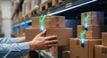 Worker handling inventory boxes with digital confirmation in a modern warehouse aisle Royalty Free Stock Photo