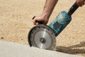 Worker hands holding angle grinder with diamond cutting disc for concrete Royalty Free Stock Photo