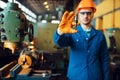 Worker hands holds detail, lathe on background