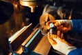 Worker hands holds detail, lathe on background