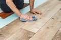 Worker hands installing timber laminate floor. Easy and quick installation of the flooring - connecting laminate locks - DIY Royalty Free Stock Photo