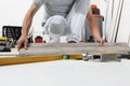 Worker hands installing timber laminate vinyl floor. Wooden floors house renovation