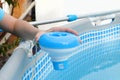 Worker hands isinfection and chlorination of water in the pool. Purification from pollution pool chlor dispenser Royalty Free Stock Photo
