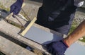 Worker hands in protective gloves preparing PVC window sill cutting metal with scissors closeup Royalty Free Stock Photo