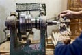 Worker hands using woodturning lathe tool and industry tools