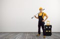 Worker handyman repairman or builder with construction spirit level and tool-box