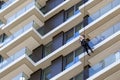 Worker hanging on climbing rope