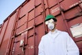 Worker in hazmat suit, hard-hat and face mask