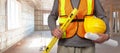 Worker with helmet in orange security vest. Royalty Free Stock Photo