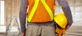 Worker with helmet in orange security vest. Royalty Free Stock Photo