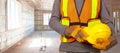 Worker with helmet in orange security vest. Royalty Free Stock Photo