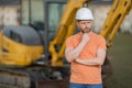 Worker in helmet on site construction. Man excavator bulldozer worker. Construction driver worker with excavator on the